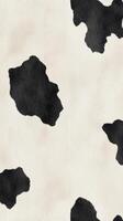A detailed cowhide pattern features prominent black patches on a soft white background, illustrating natural beauty and unique textures found in cow skins photo