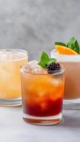 Three vibrant cocktails sit on a sleek surface, showcasing a mix of flavors and garnishes, perfect for enjoying during an evening with friends or celebrations photo