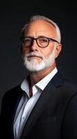 A mature gentleman with silver hair and a neatly groomed beard exudes confidence while wearing a formal suit in a dark background photo