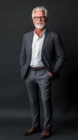 A man stands confidently with his hands in his pockets, showcasing a smart casual look in a stylish indoor setting illuminated by soft lighting photo
