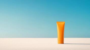 An orange tube of sunscreen stands upright on a white surface, reflecting the vibrant sunlight against a clear blue sky, ideal for summer activities photo