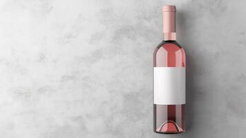 A rose wine bottle featuring a clear glass design and blank label is positioned on a textured gray background, perfect for branding or personal use photo
