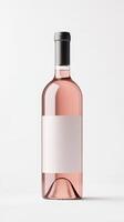 A sleek rose wine bottle stands alone against a plain background, highlighting its elegant shape and soft pink hue. The blank label invites creativity photo