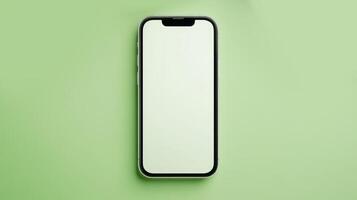 A sleek smartphone lies flat on a light green background, showcasing a blank screen, perfect for showcasing apps or customization options photo