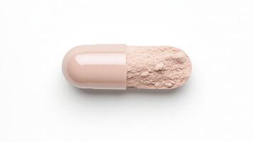 A large beige capsule is opened, with fine light powder spilling out, resting on a clean white surface, illustrating a pharmaceutical preparation photo
