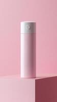 A sleek pink water bottle stands upright on a pastel pink platform, showcasing its minimalist design that blends with the tranquil surroundings photo