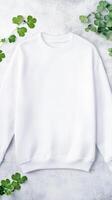White sweatshirt mockup with shamrock leaves photo