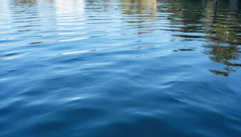 The surface of rippling water, reflecting the sky and surrounding landscape with distortion. photo