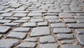 A cobblestone street, worn smooth by centuries of foot traffic, with subtle variations in color and texture. photo