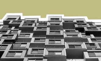 Building with gray exterior. Modern high rise multistorey condominium in developing downtown photo