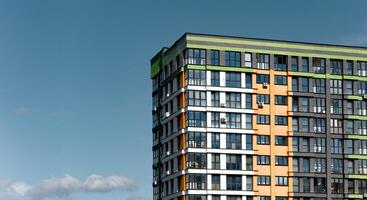Building with modern architecture. High rise condominium with clear blue sky, sunny downtown photo