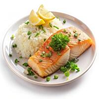 Delicious pan seared salmon with fluffy rice lemon herbs on a plate photo