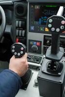 Control system used in heavy machinery during operation at a construction site showcasing the interface and joysticks for precise maneuvering of equipment photo