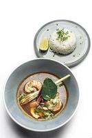 thai tom yam kung spicy soup with prawns on white background photo