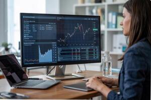 Modern office desk and computing setup highlighting financial trading activities in a sleek workspace environment photo