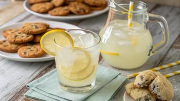 Lemonade with cookies and lemon slices photo