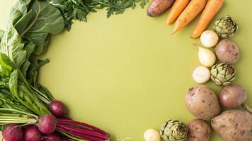 Vegetables arranged in a circle on a green background photo