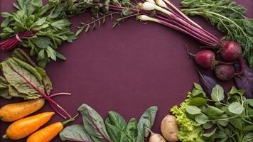 Various vegetables arranged in a circle on a purple background photo