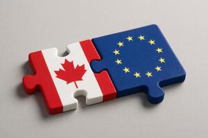 Canada and European Union Puzzle Pieces Representing International Unity and Cooperation Concept photo
