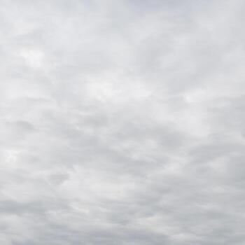 Cloudy Sky Texture with White and Gray Clouds Overcast Background with Copy Space for Atmospheric Designs photo