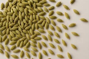Fresh Fennel Seeds Scattered on White Background for Culinary and Herbal Use photo