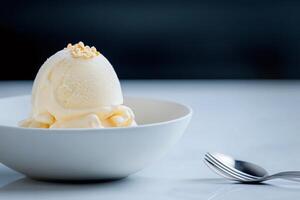 Scoop of vanilla ice cream melting in bowl with toasted almond flakes photo
