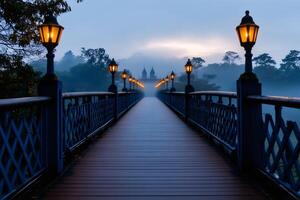 Wooden bridge with illuminated street lamps leading to a temple in the fog at dawn photo