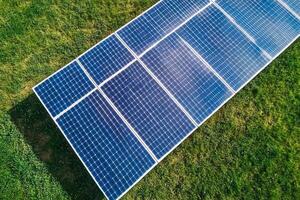 An aerial view of a solar panel on a green field photo