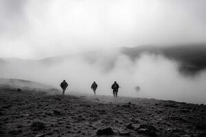 Three people walking in the fog on a mountain photo