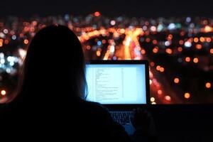 A person sitting at a desk with a laptop computer in front of them photo