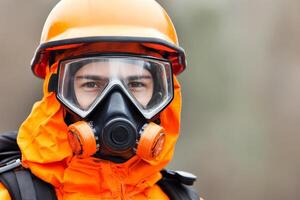 A man in an orange gas mask and helmet photo