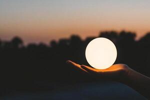 A person holding a light up egg in their hand photo