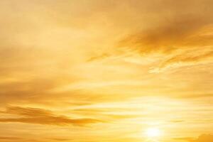 A man is standing on a hill with a large sun in the background photo