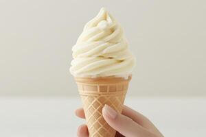 A person holding an ice cream cone with a white swirl photo