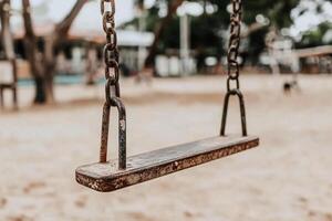 A swing is shown in a playground photo