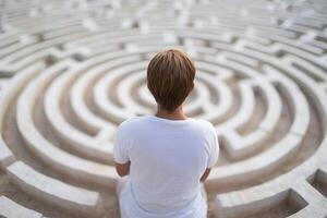 A person sitting in front of a maze photo