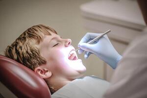 A boy is getting his teeth cleaned by a dentist photo