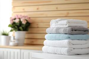 A stack of towels on a table in a bathroom photo