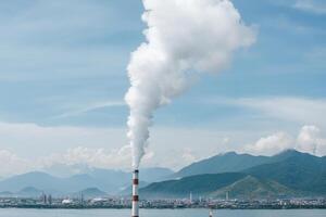 A large pipe with smoke coming out of it photo