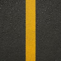 Black Asphalt Road Surface Texture With Yellow Line Top Down View for Urban Design and Infrastructure Themes photo