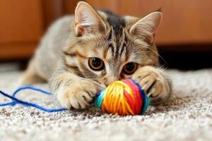 A cat playing with a ball of yarn photo