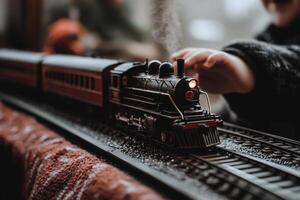 A child playing with a toy train on a table photo