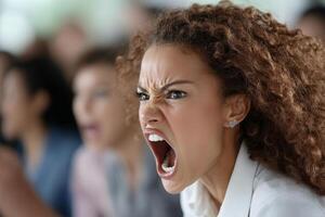 A woman with an angry face yelling in a meeting photo