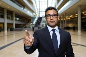 A man in a suit and tie pointing at something photo