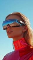 A model showcases modern reflective sunglasses while dressed in a vibrant outfit, with a clear blue sky and desert landscape in the background photo