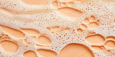 Bubbles and soft textures swirl together in a warm peach tone, creating an abstract art reminiscent of a creamy beverage foam close-up photo
