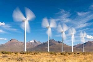 Wind turbines in the desert with mountains in the background photo