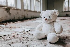A teddy bear sits in an abandoned building photo