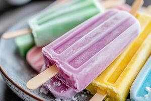 Popsicles are colorful and have different colored ice cream photo
