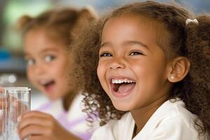 Two children are laughing while holding up test tubes photo